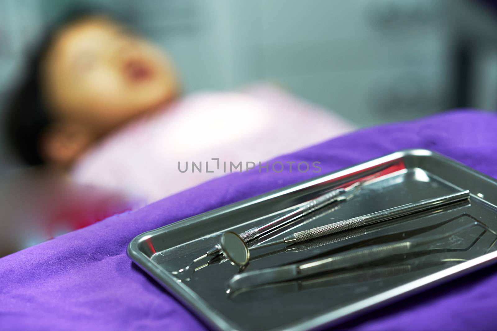 Dentist tools on tray on blur background