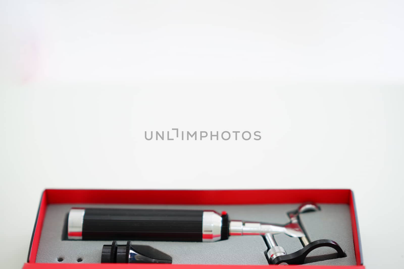 Otoscope for ear check for doctor ENT in box on blur background