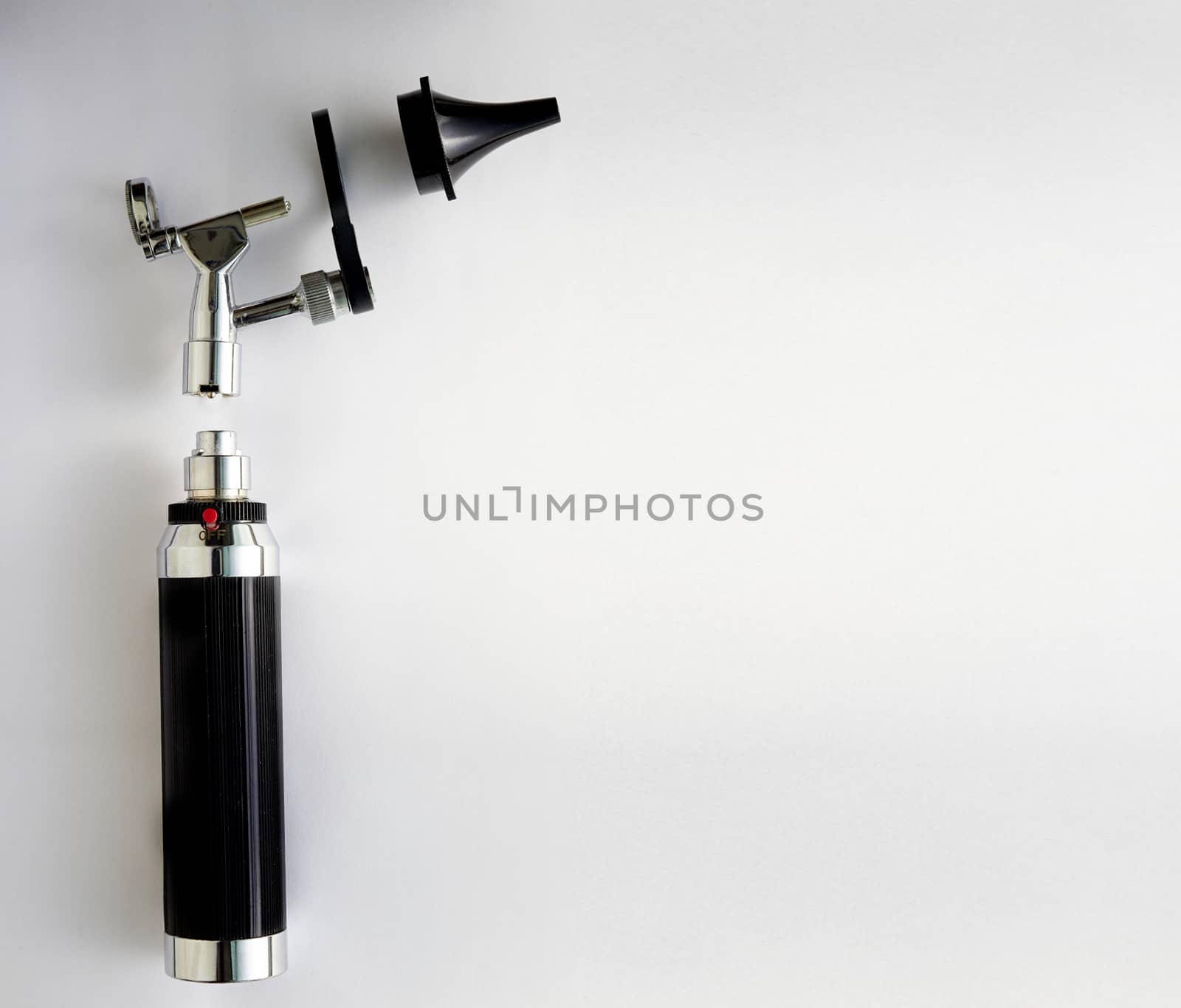 Otoscope for ENT doctor exam ear on pieces disassembly with copy space on white background