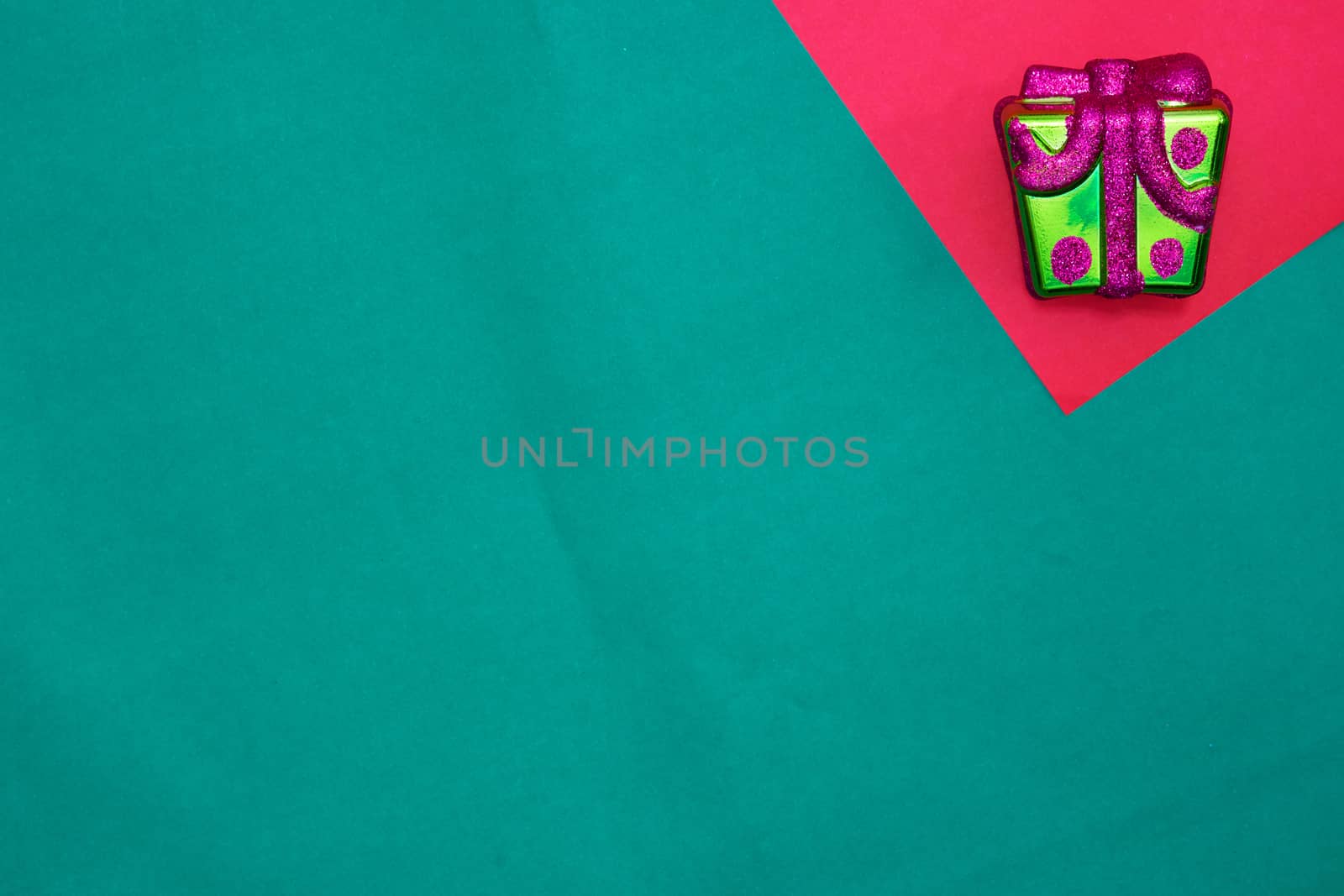 Present box on red and green background with copy space for new year and christmas time