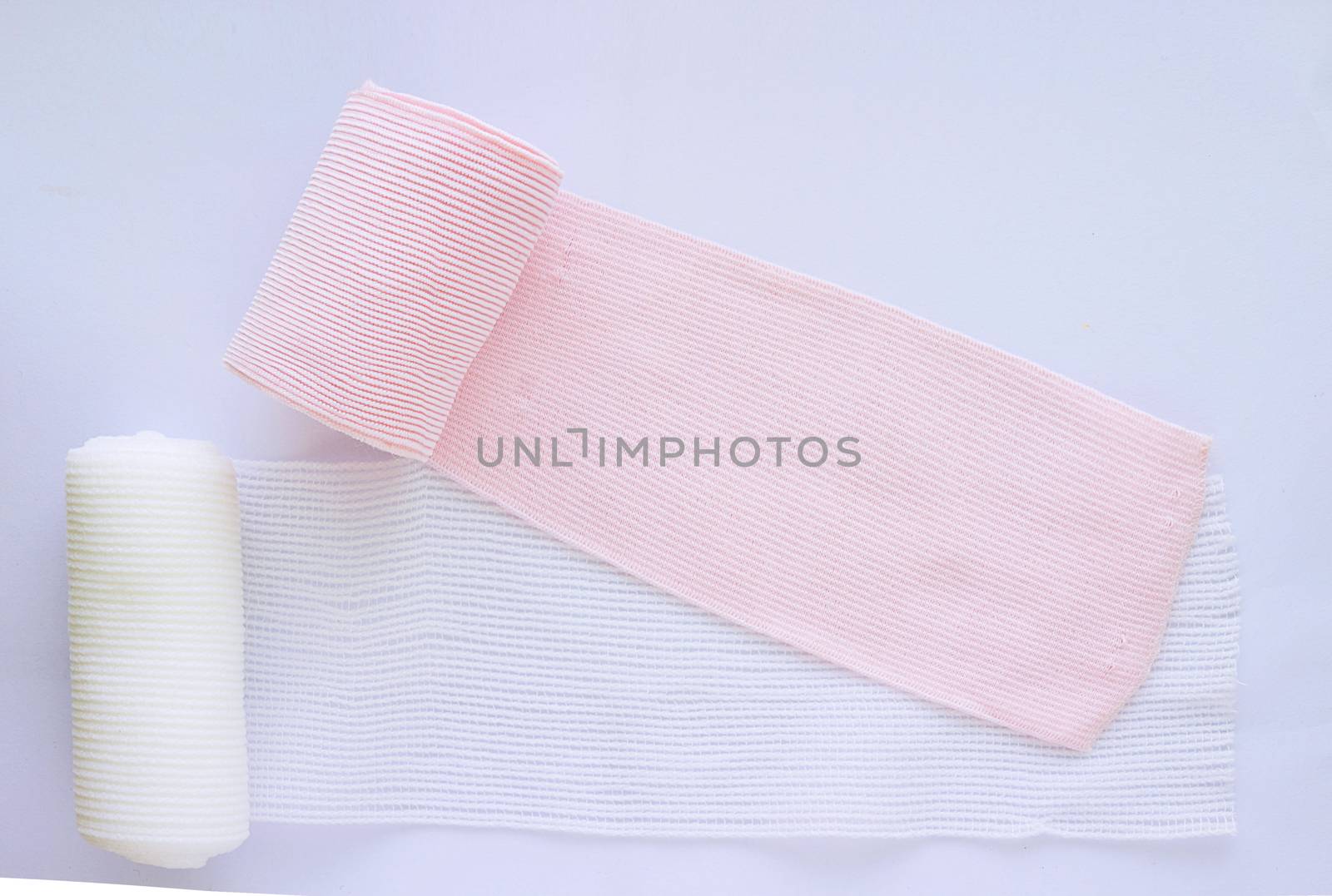 Roll elastic bandage and gauze on white background