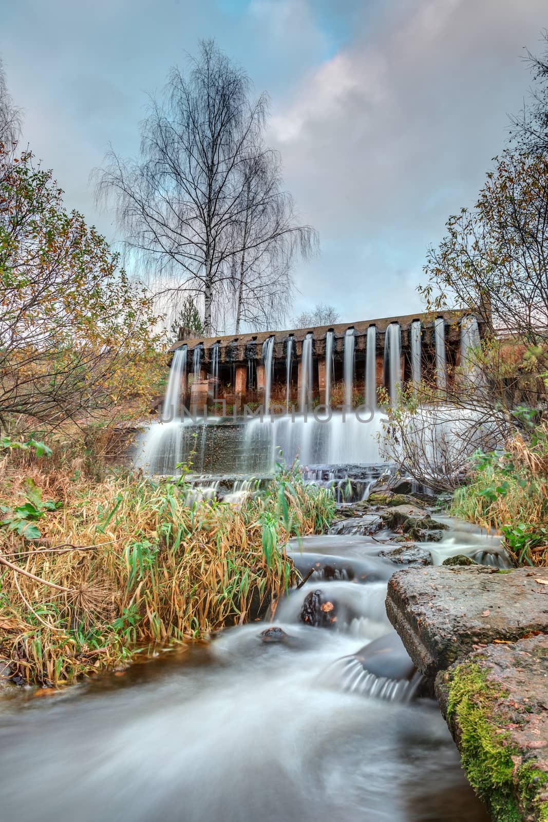 dam with a waterfall on the river by sveter