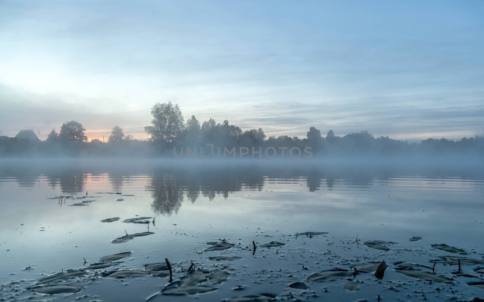 River before sunrise in the fog by sveter