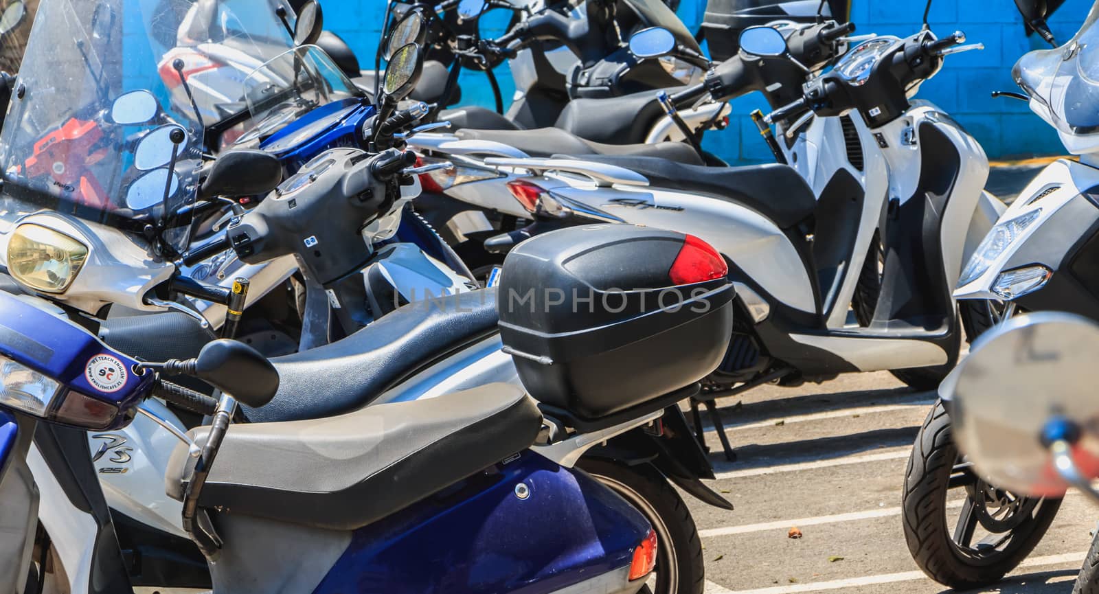 closeup of a parking for scooter in the city center on a summer  by AtlanticEUROSTOXX