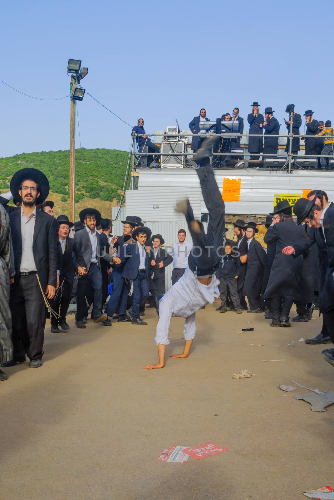 MERON, ISRAEL - MAY 26, 2016: Orthodox Jews dance at the annual hillulah of Rabbi Shimon Bar Yochai, in Meron, Israel, on Lag BaOmer Holiday. This is an annual celebration at the tomb of Rabbi Shimon