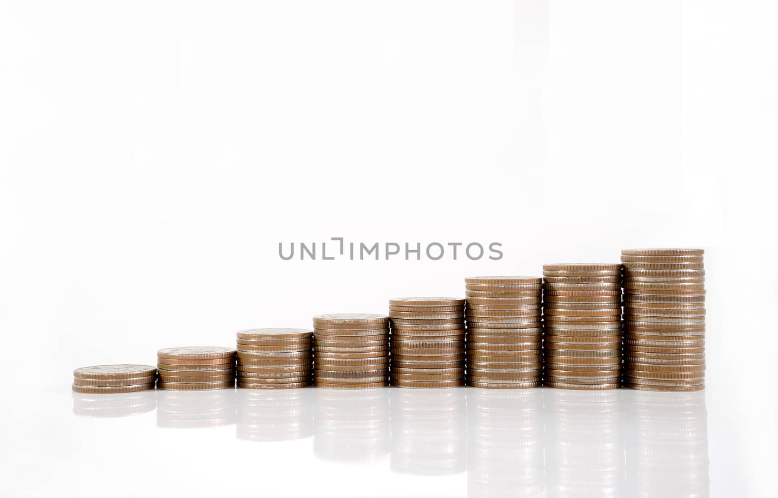 Savings, increasing columns of coins isolated on white background