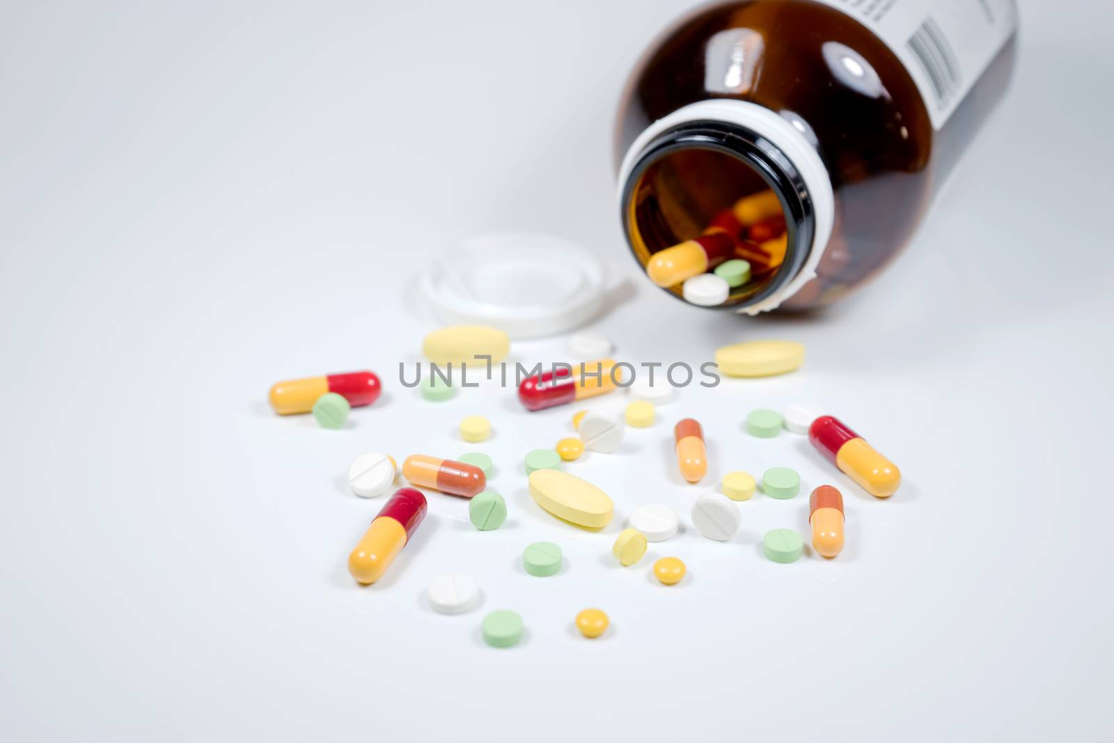 Pills from bottle on the white