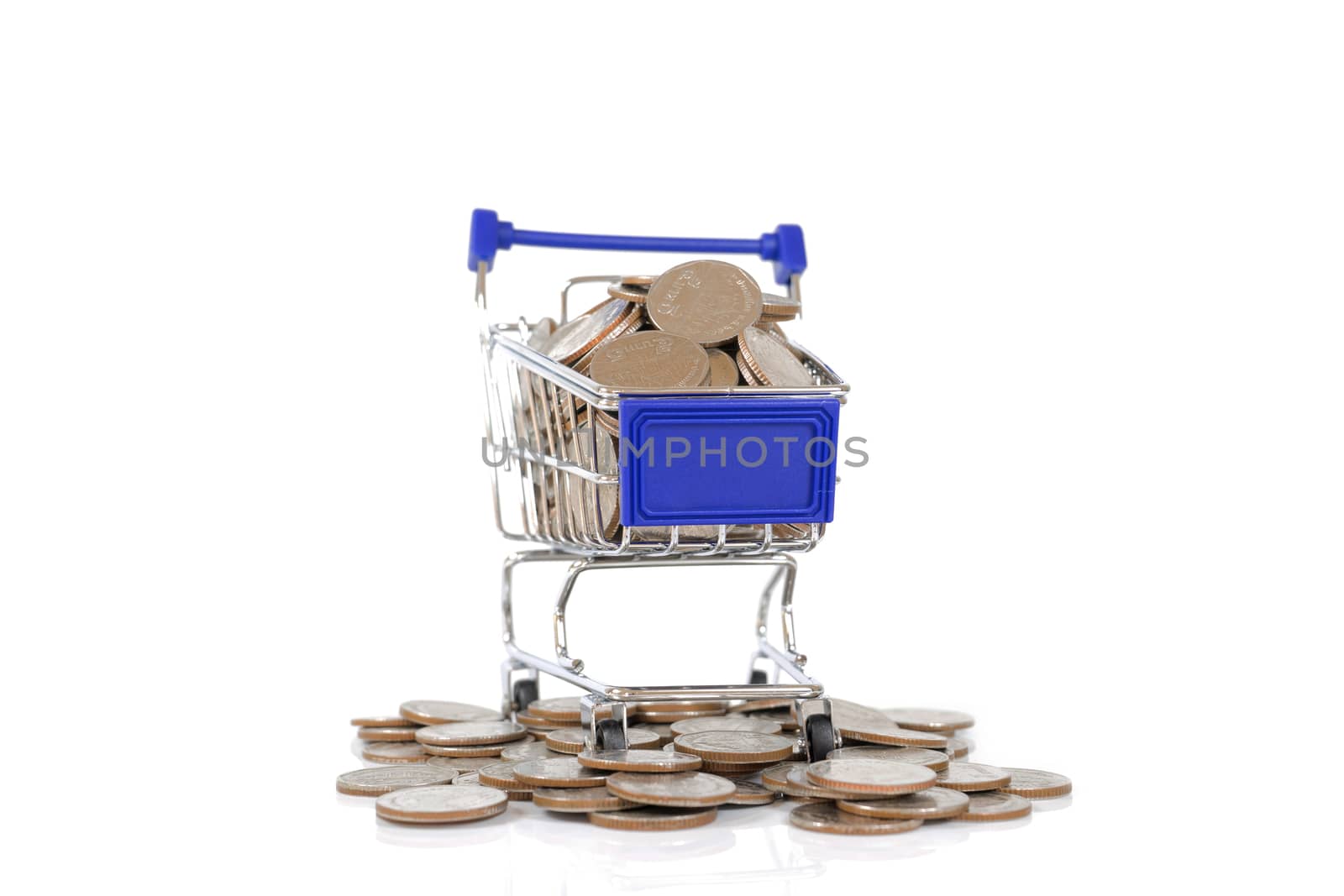 Mini shopping cart with coins on white background