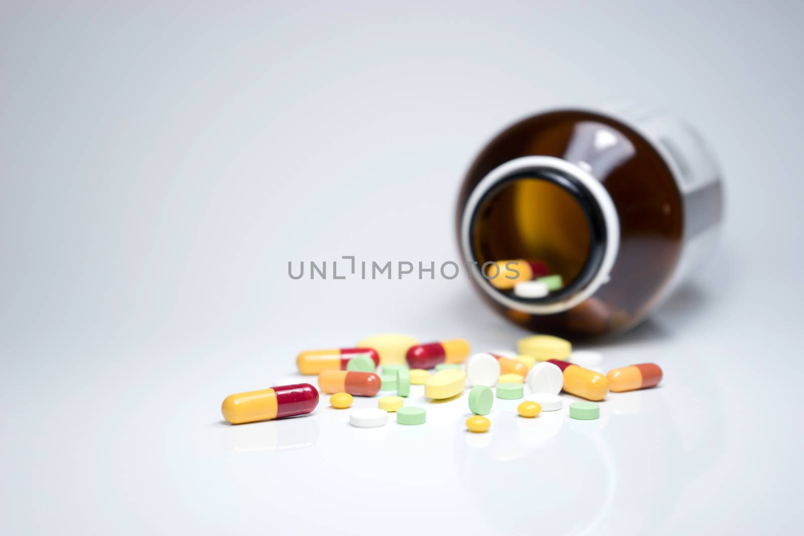 Pills from bottle on the white