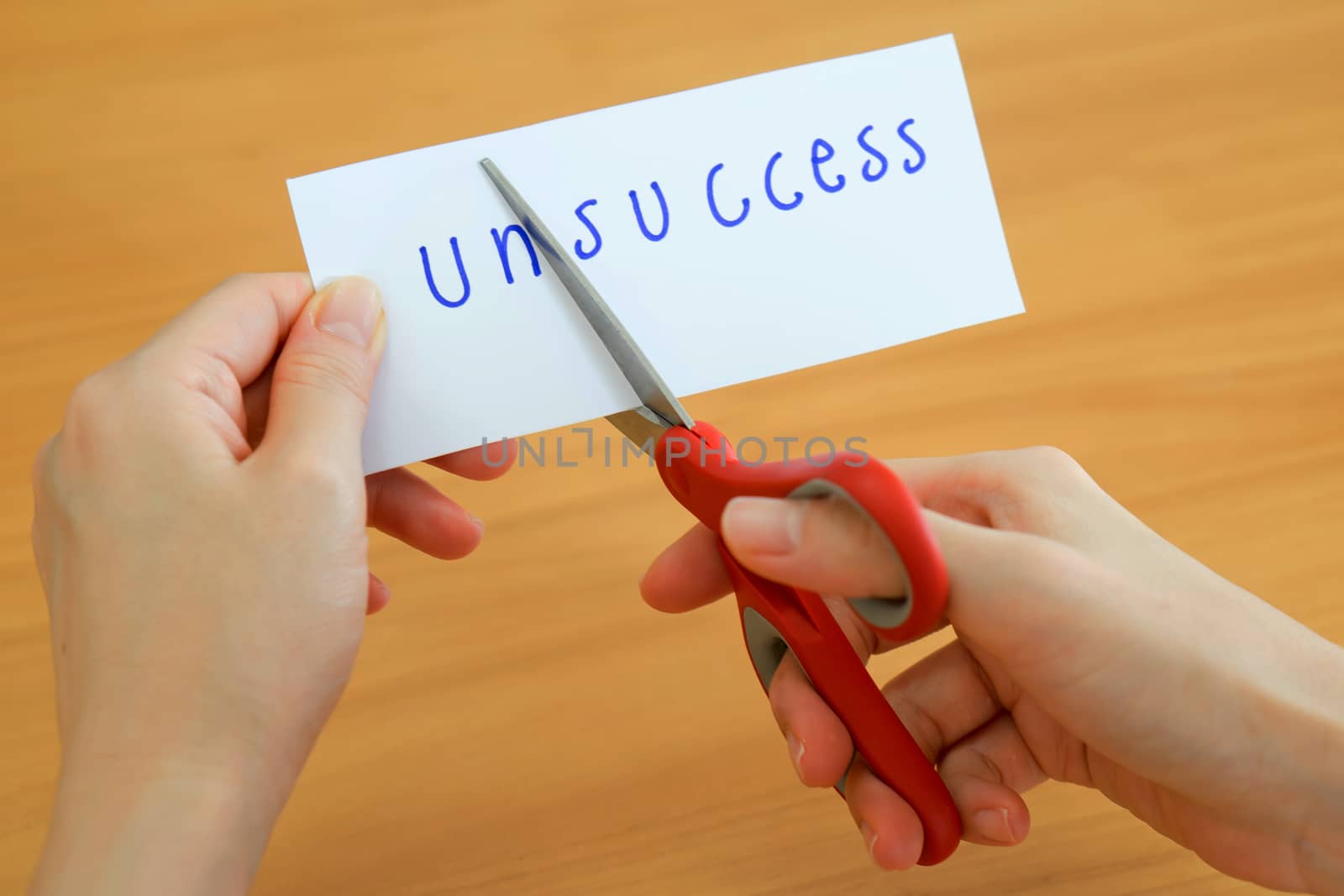holds card with text unsuccess on wood plate