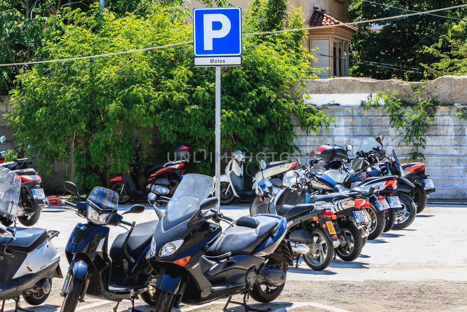 BARCELONA, SPAIN - June 20, 2017 : closeup of a parking for scooter in the city center on a summer day