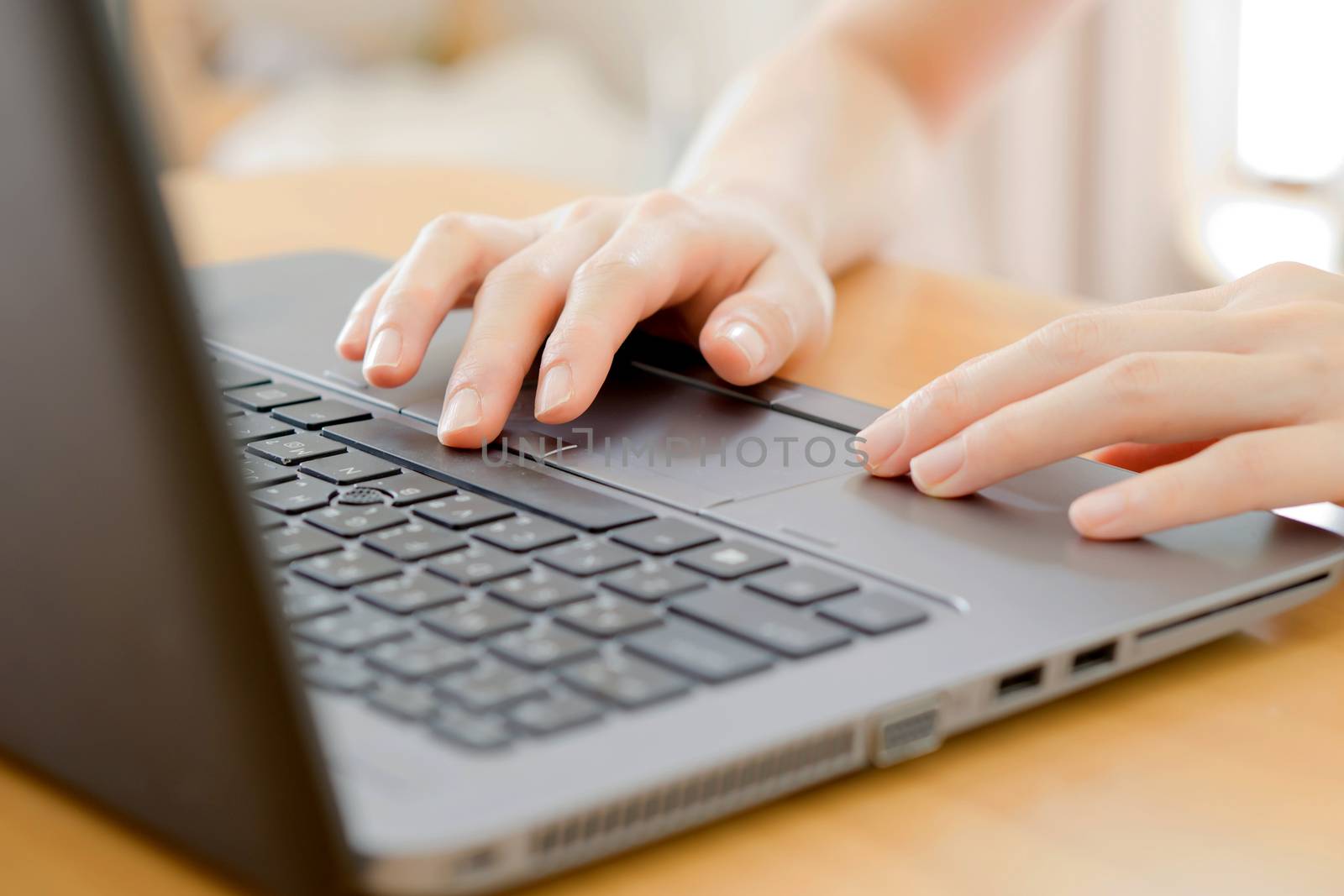 programmer's hand typing with laptop. focus on his finger 