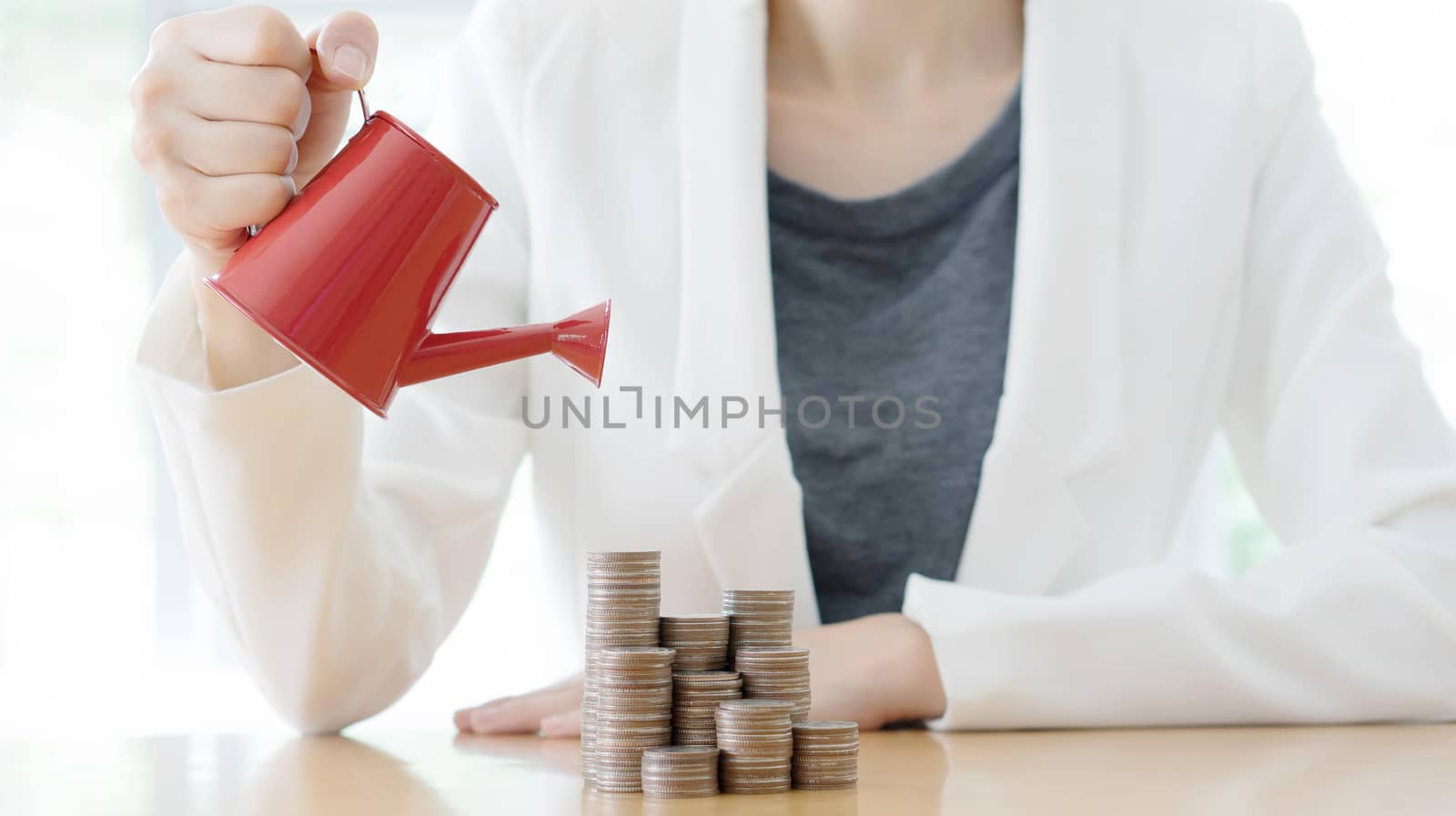 hand business woman and red watering can with money