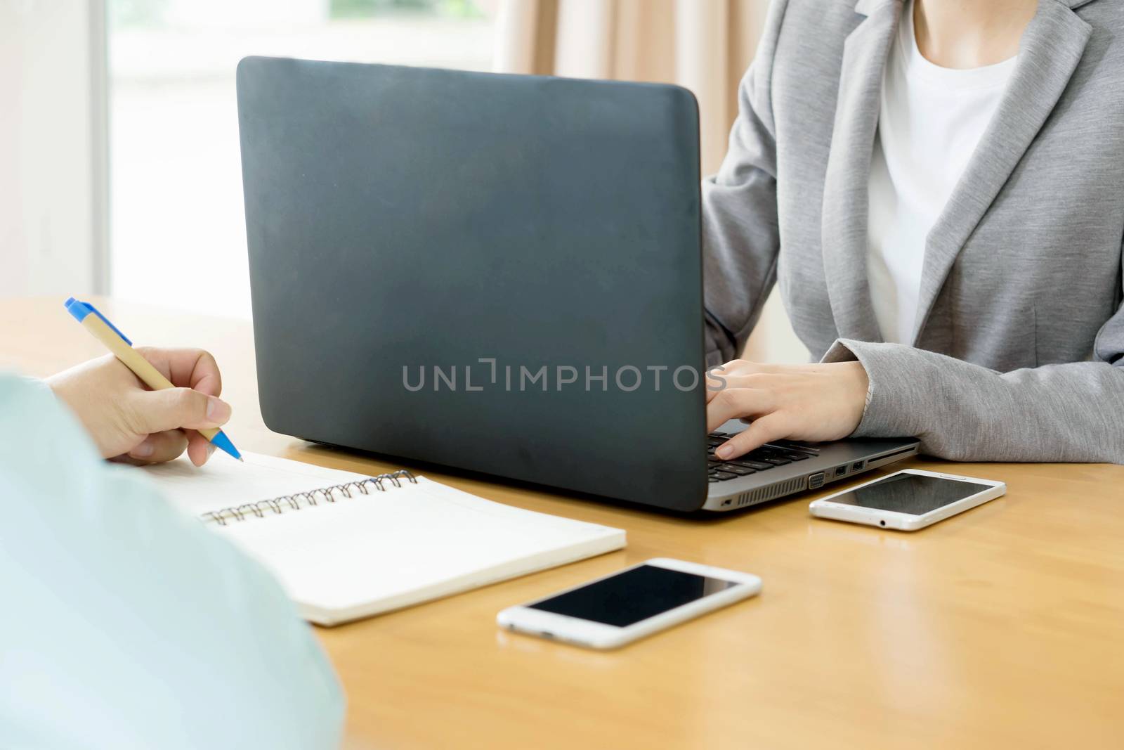 Business team hands at work with financial reports and a laptop
