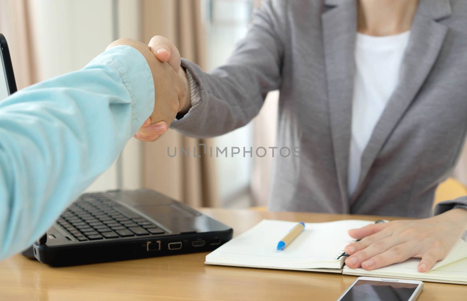 Manager interviewing a male applicant in her office