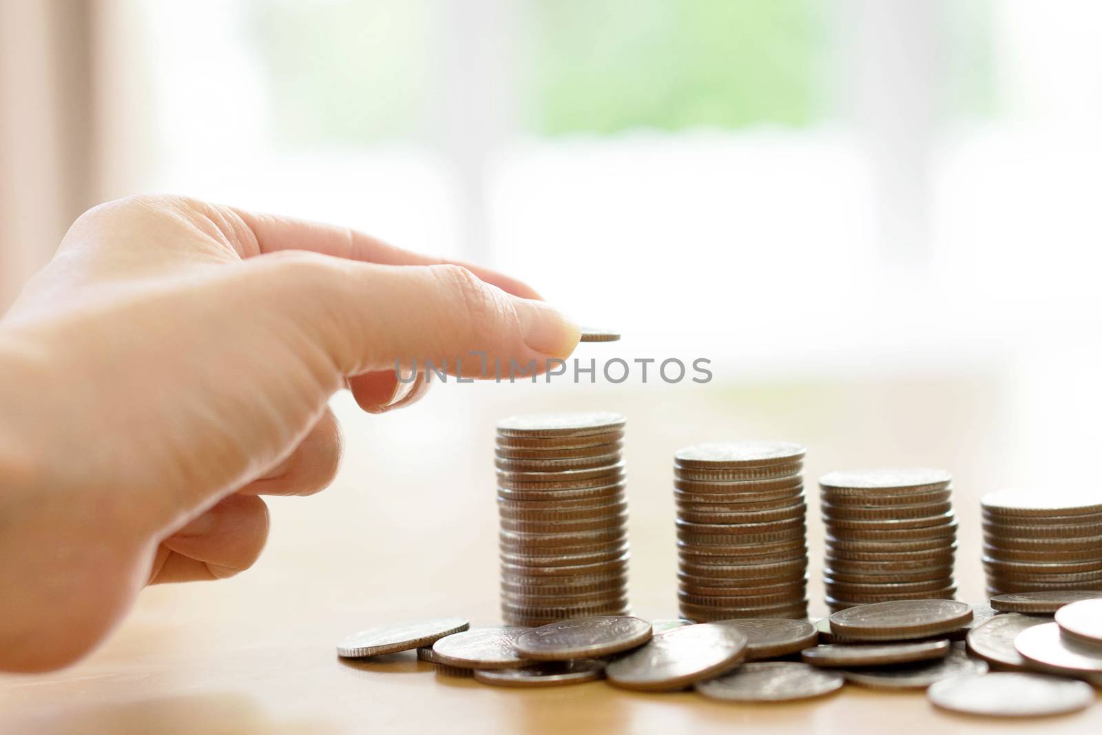 Saving money concept,Male hand putting money coin stack growing business