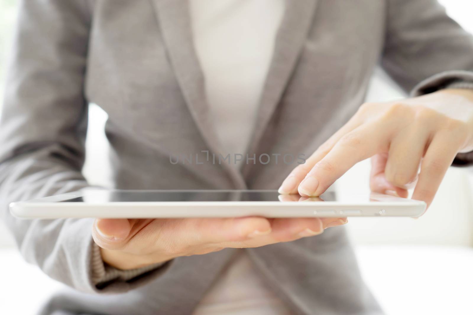 Digital tablet in the hands of businesswomen