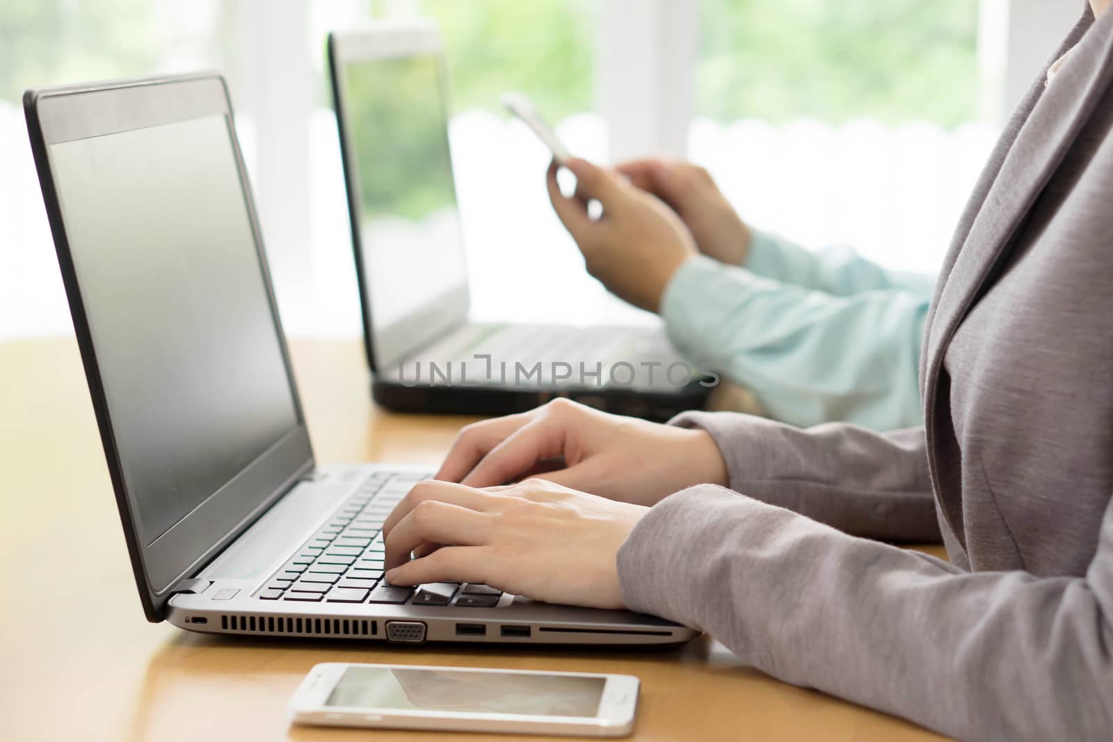 Workers At Desks In Busy Creative Office
