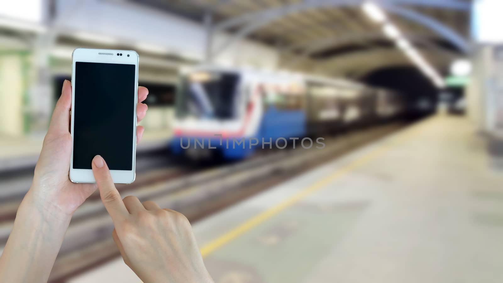 Hand are holding and touch Smartphone with sky train background