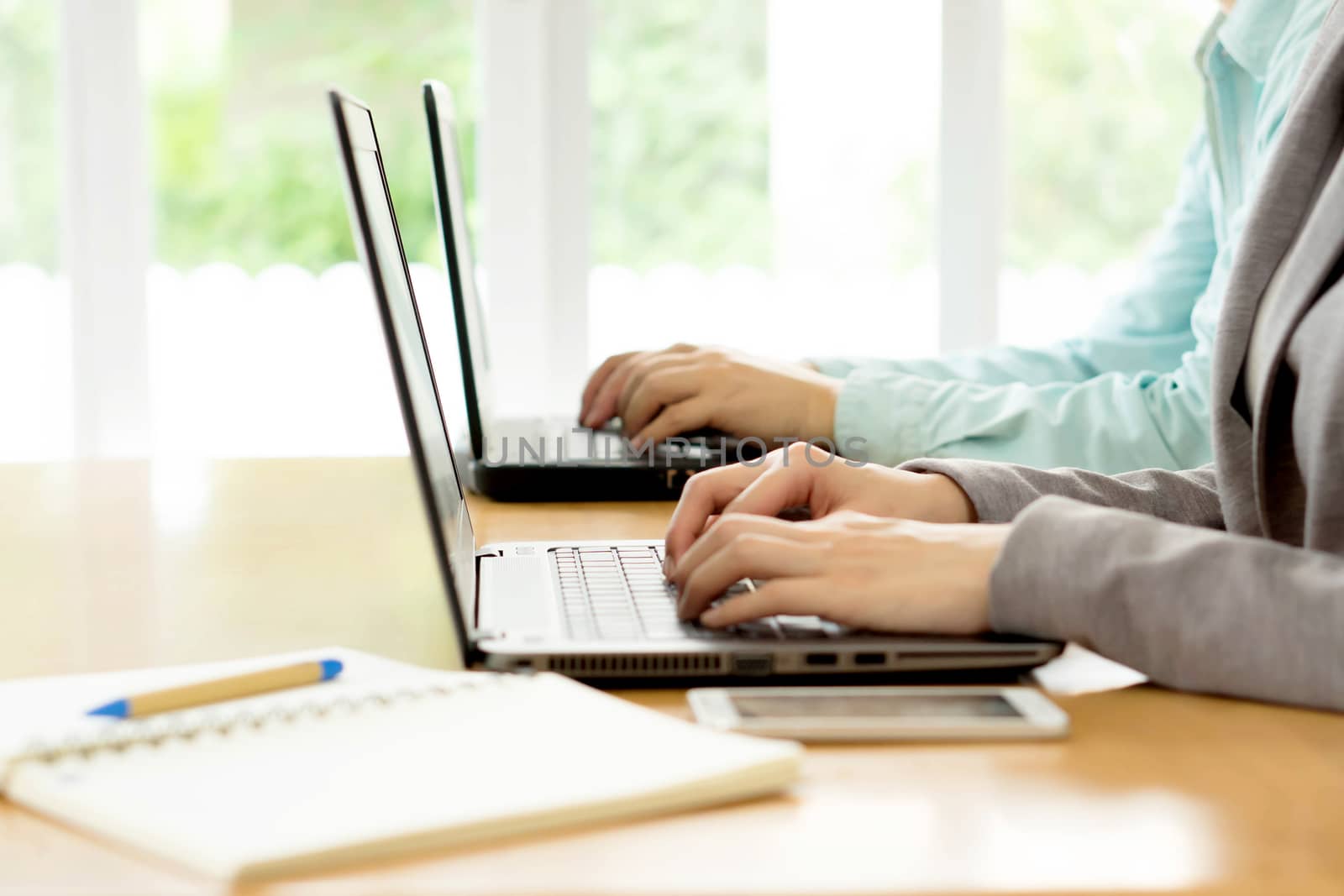 man and woman working on their computers.