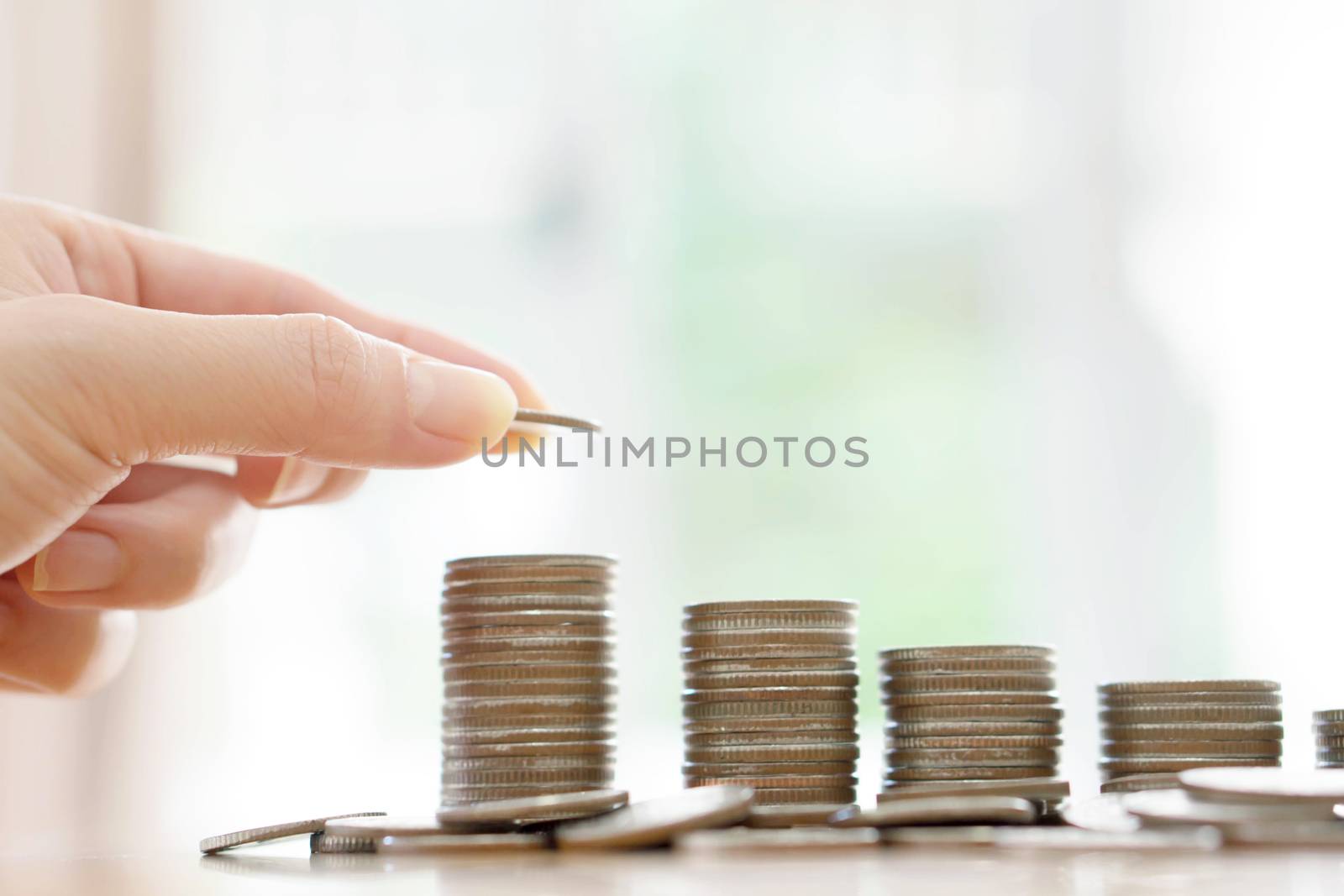 Saving money concept,Male hand putting money coin stack growing business
