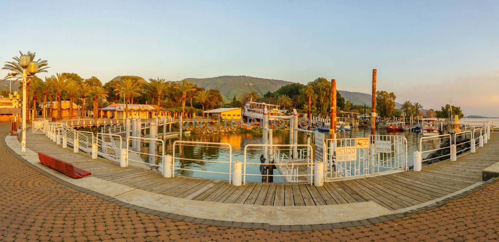Ein Gev, Israel - April 03, 2019: Panoramic sunset view of the fishing port of Kibbutz Ein Gev, on the east shore of the Sea of Galilee (Kinneret lake), Northern Israel