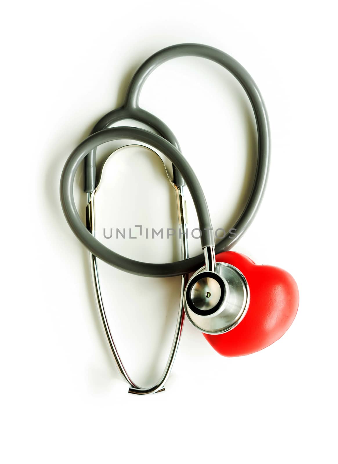 Medical stethoscope and heart isolated on white.