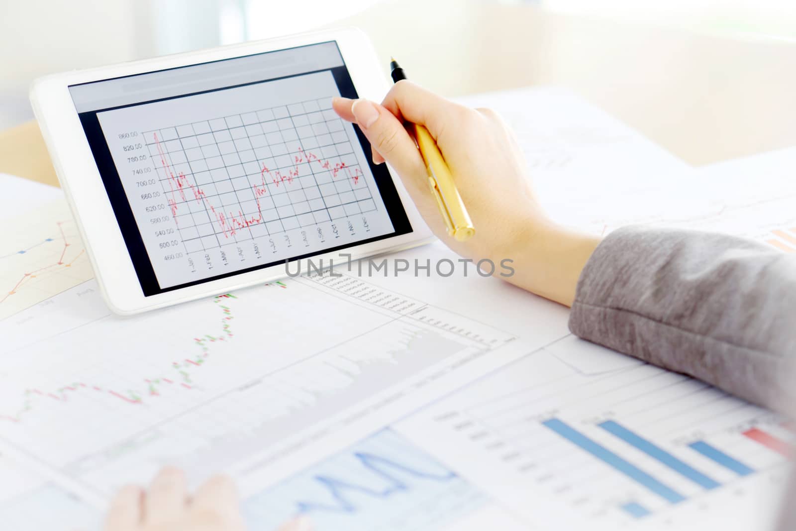 Close up hand holding digital tablet with analyzing graph,planing,business success