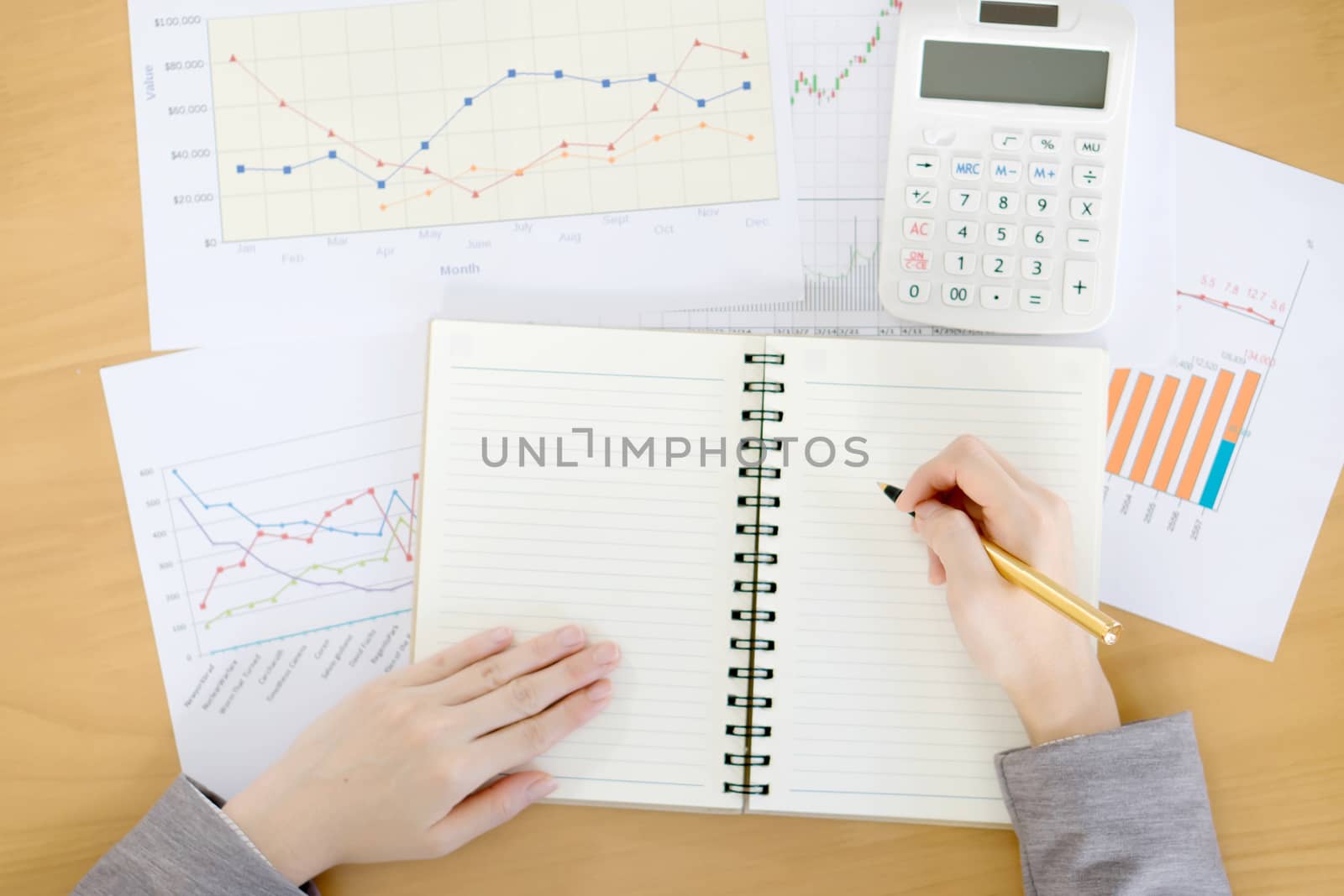 picture of woman hand with calculator and papers
