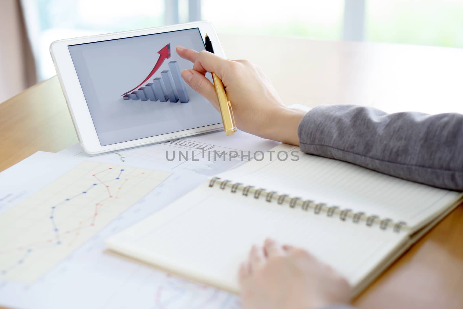 Close-up Of Businesswoman Analyzing Graph On Digital Tablet