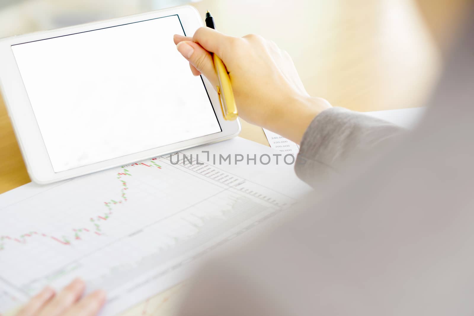 Close-up Of A Businesswoman Analyzing Graph On Digital Tablet