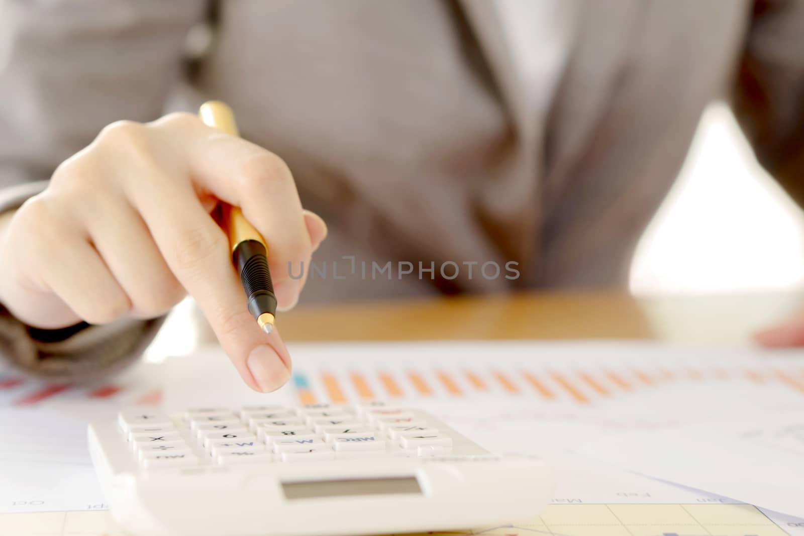 Close up of female accountant or banker making calculations. Savings, finances and economy concept