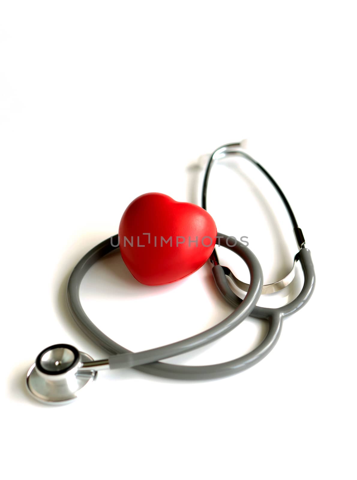 A heart with a stethoscope, isolated on white background