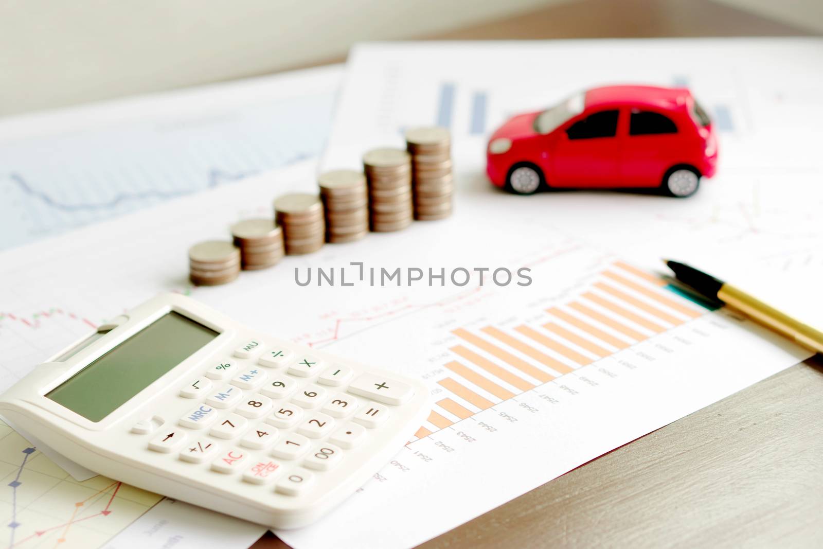  With Car Model And Stack Of Coins On Desk