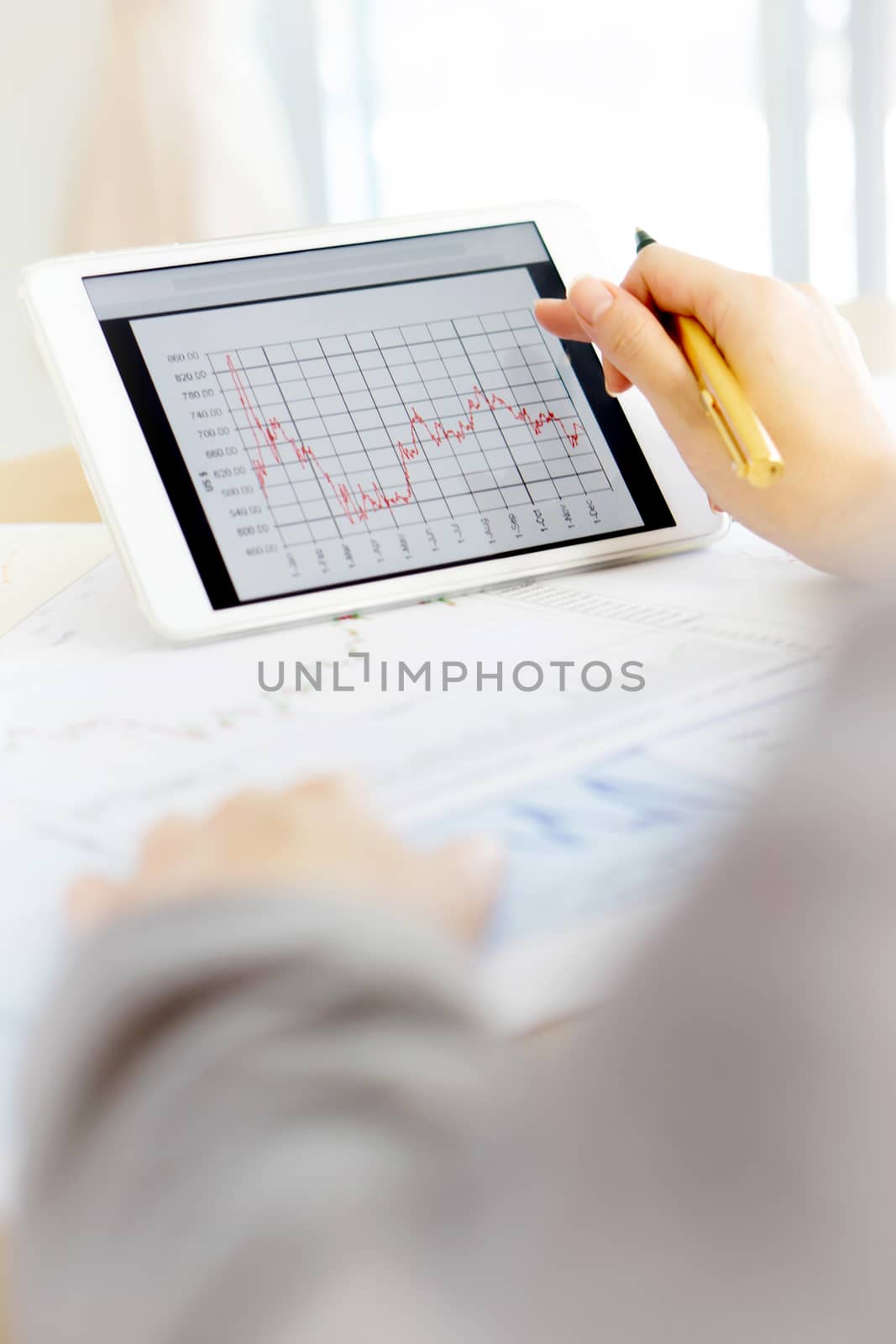 Close up hand holding digital tablet with analyzing graph,planing,business success