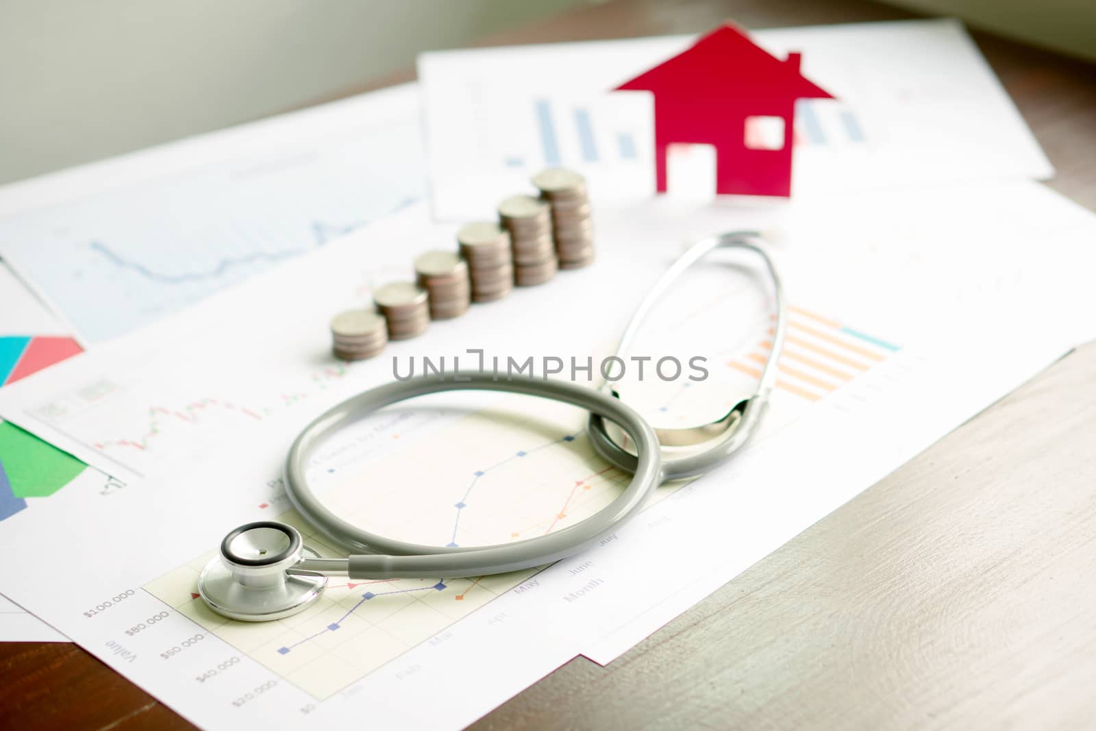 concept stethoscope car graph and coin