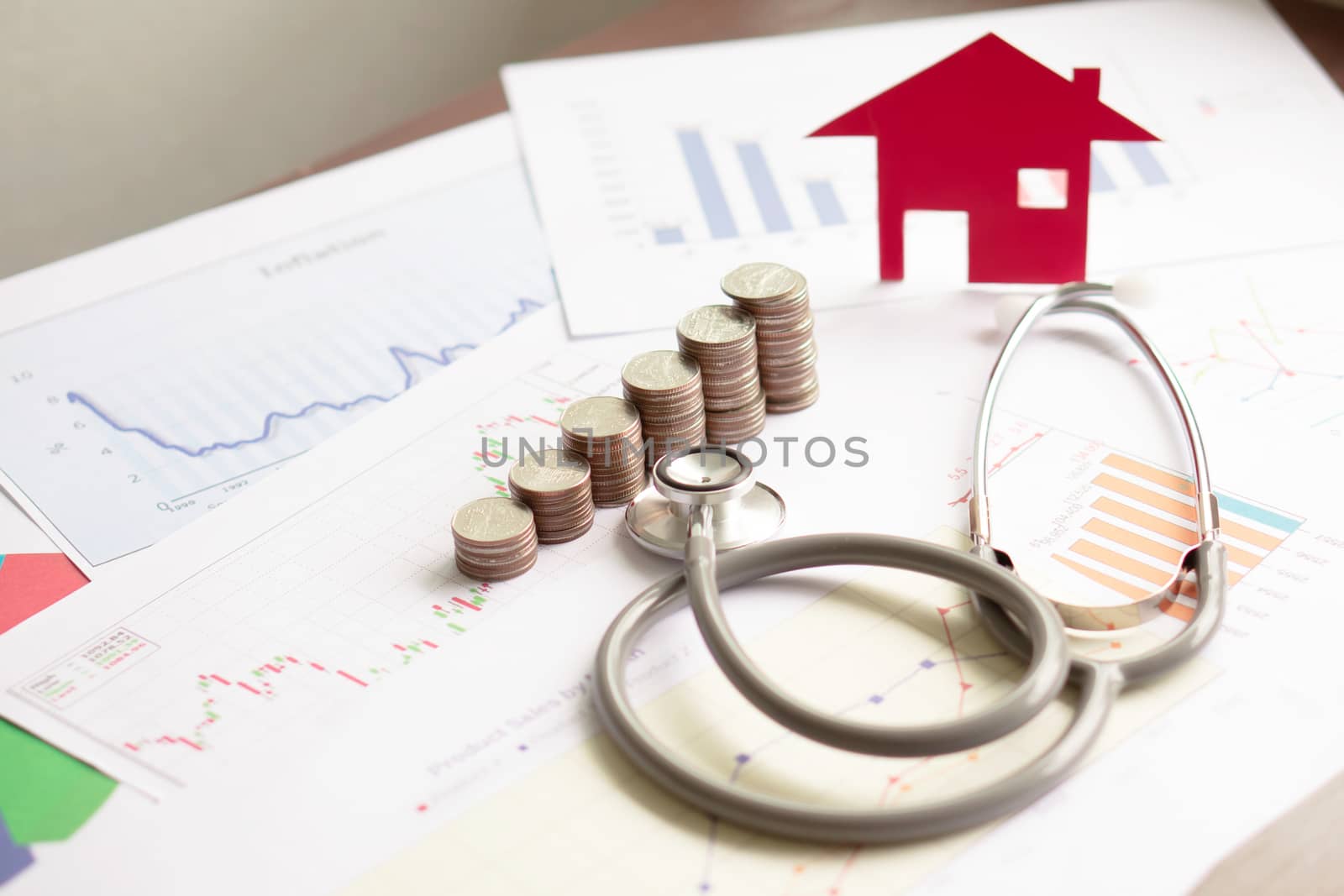 concept stethoscope car graph and coin