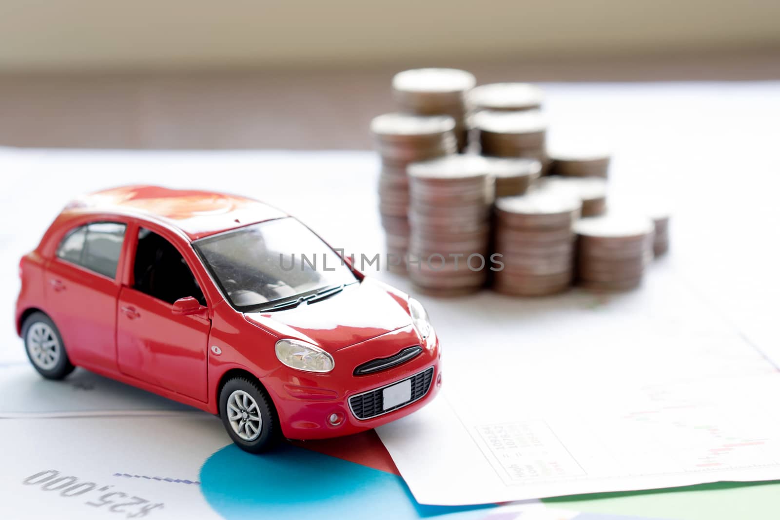 Car model and Financial statement with coins. (finance and car loan concept)