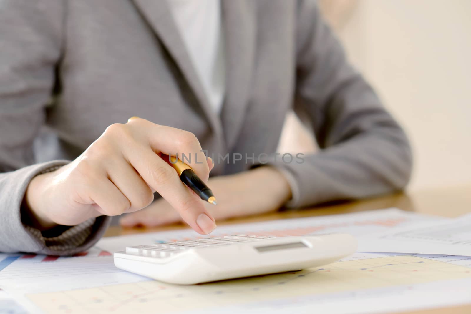 Close up of female accountant or banker making calculations. Savings, finances and economy concept