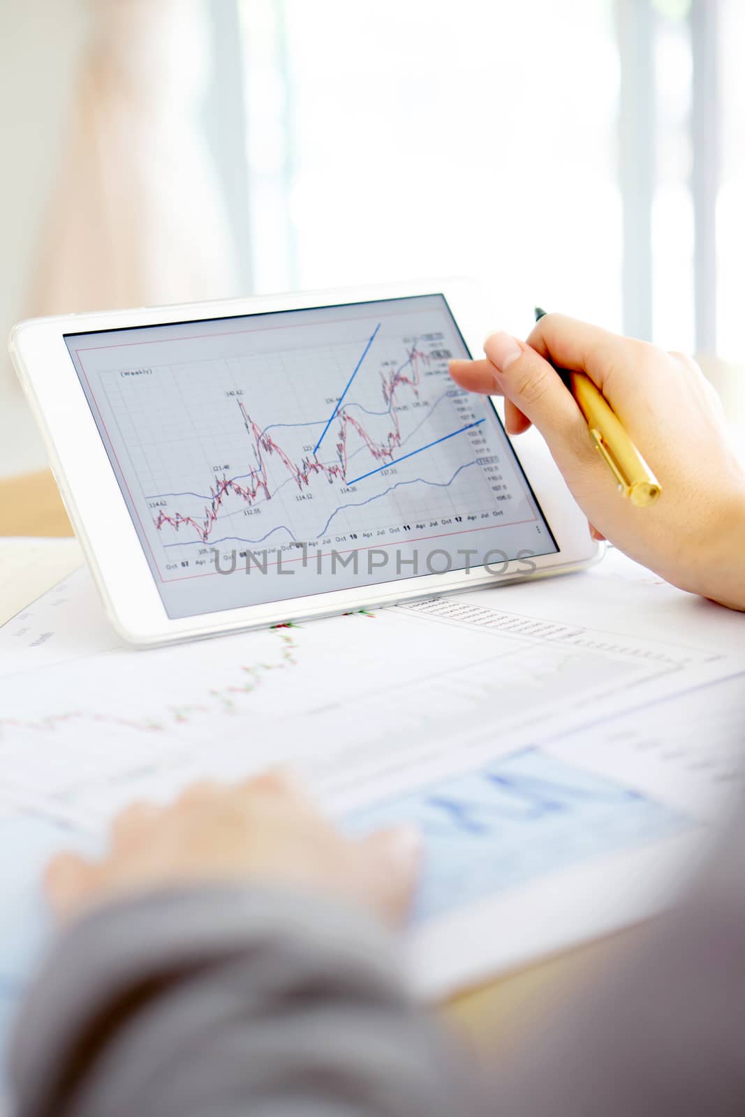 Close-up Of Businesswoman Analyzing Graph On Digital Tablet