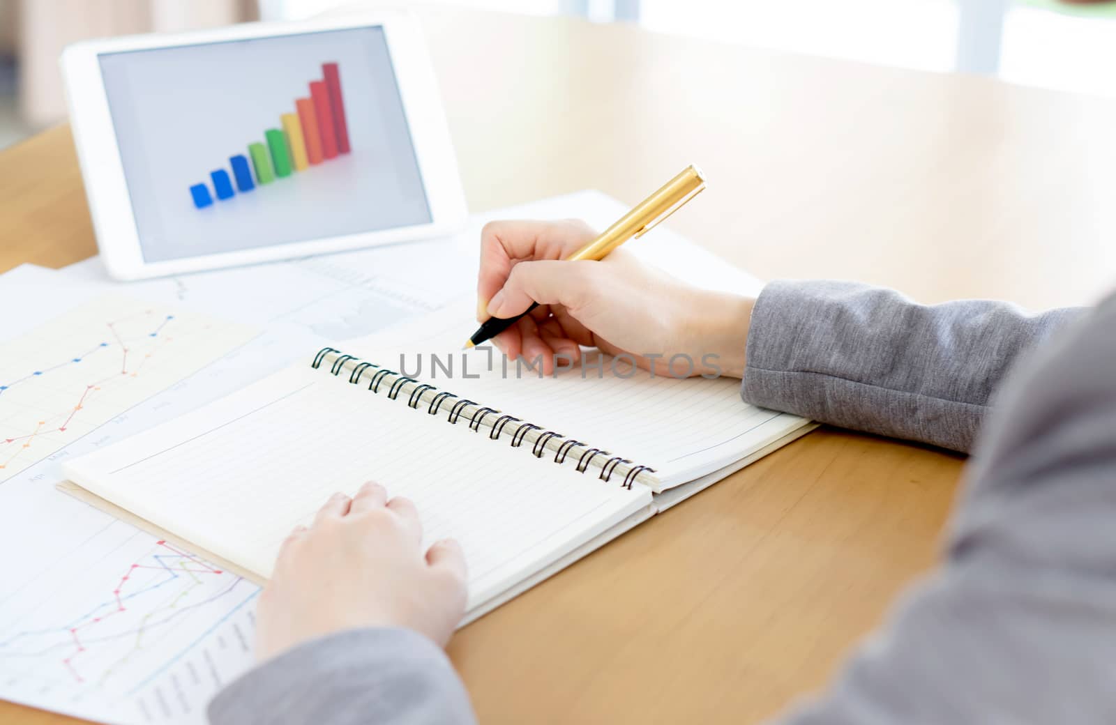 business woman analysis with financial graph at office, workplace