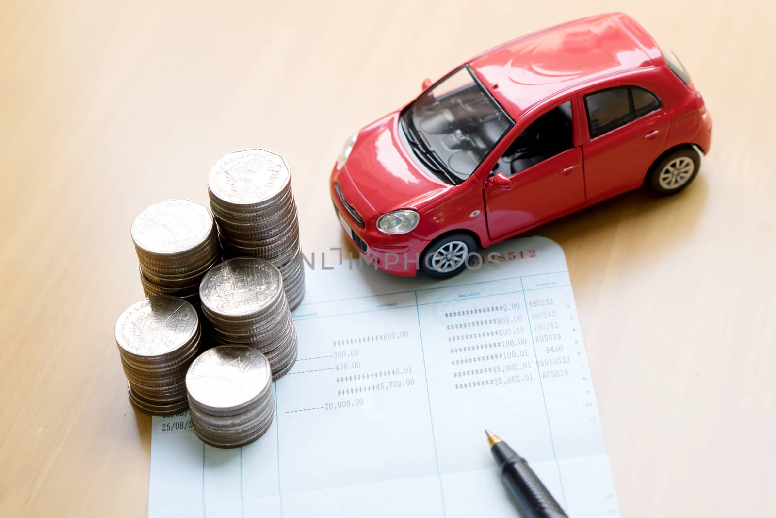 Rows of coins, account book, car. Finance and banking concept.