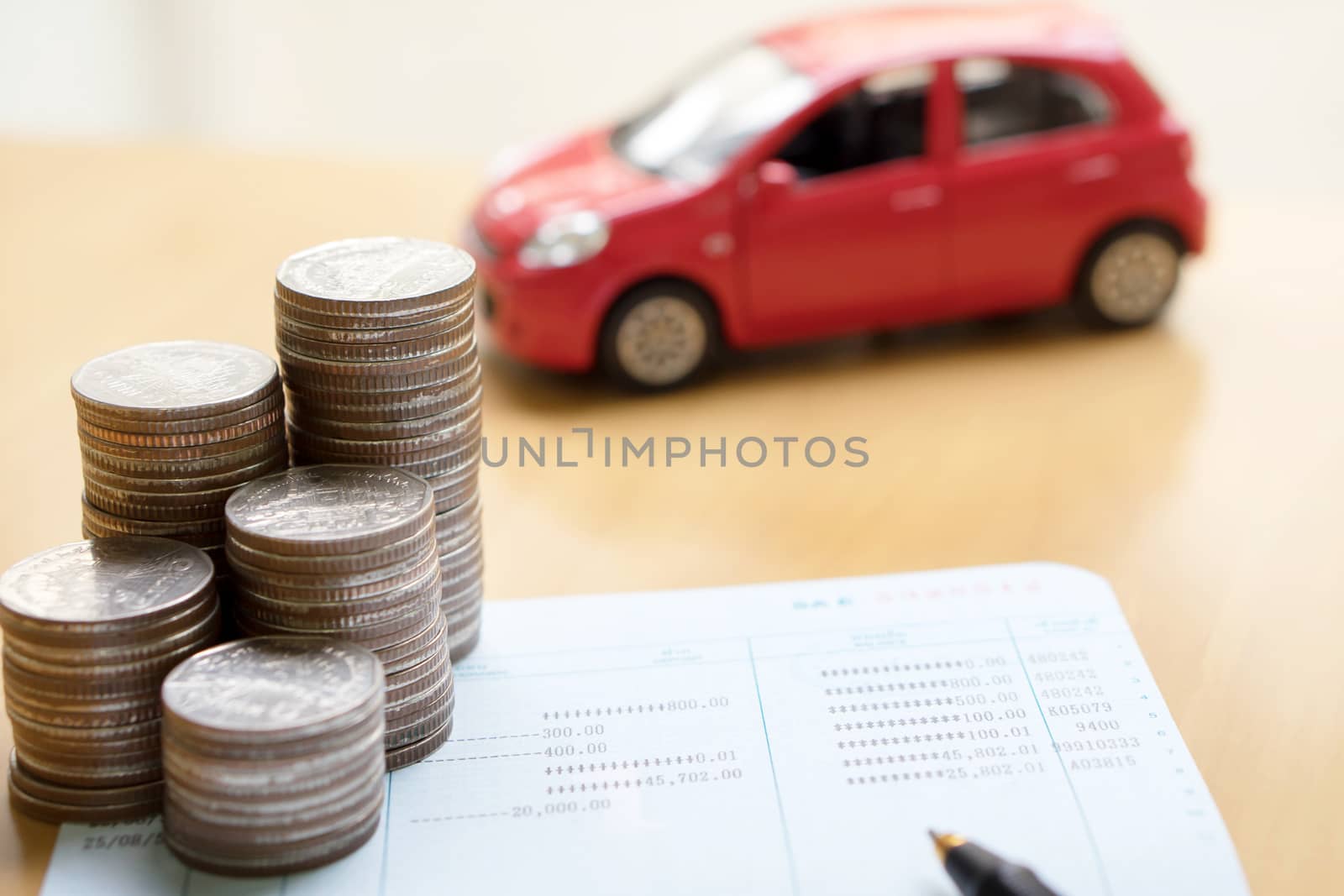 Coins stack in columns, saving book, car. Finance and banking concept.