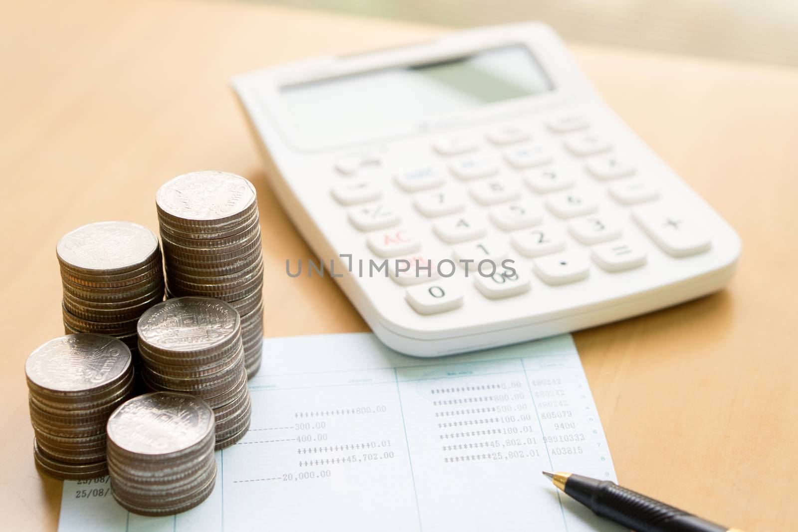 Coins stack in columns with saving book finance and banking concept for background