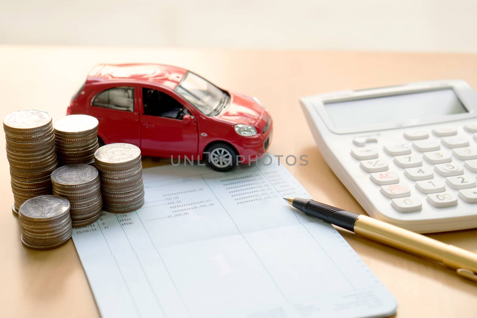 Coins stack in columns, saving book, car. Finance and banking concept.