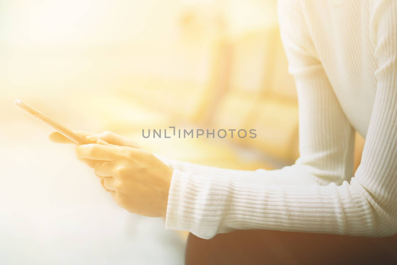 Woman at airport texting on a smartphone 