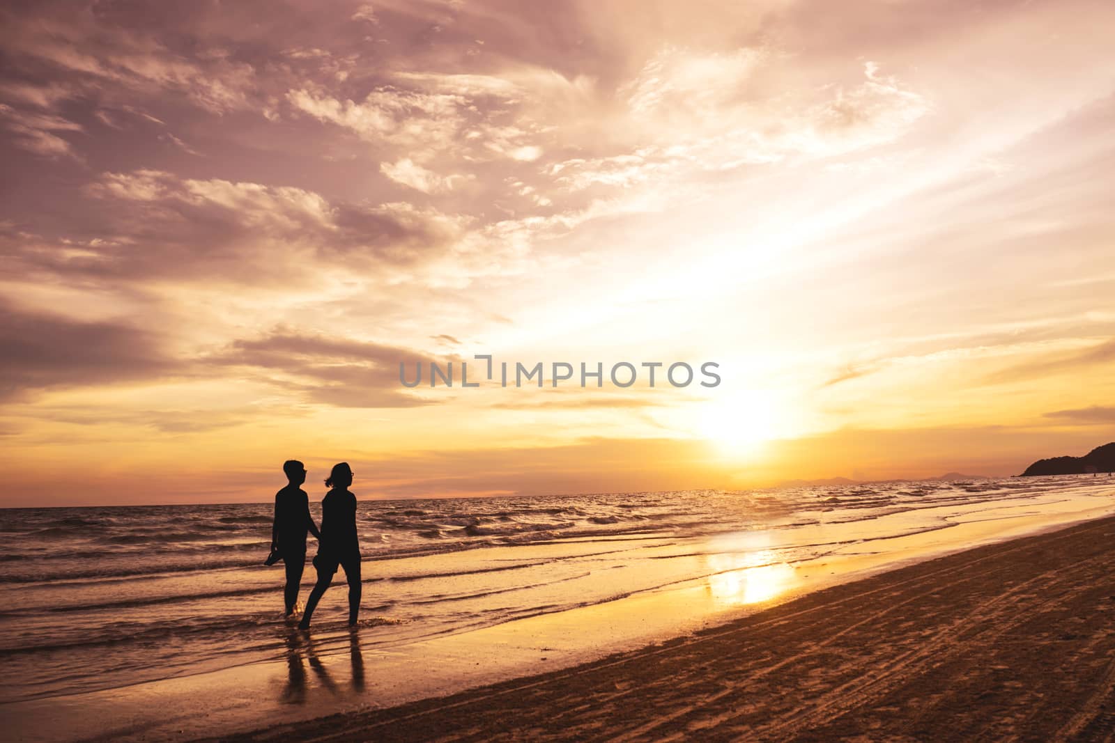 Couple Walking by the Ocean Shoreline