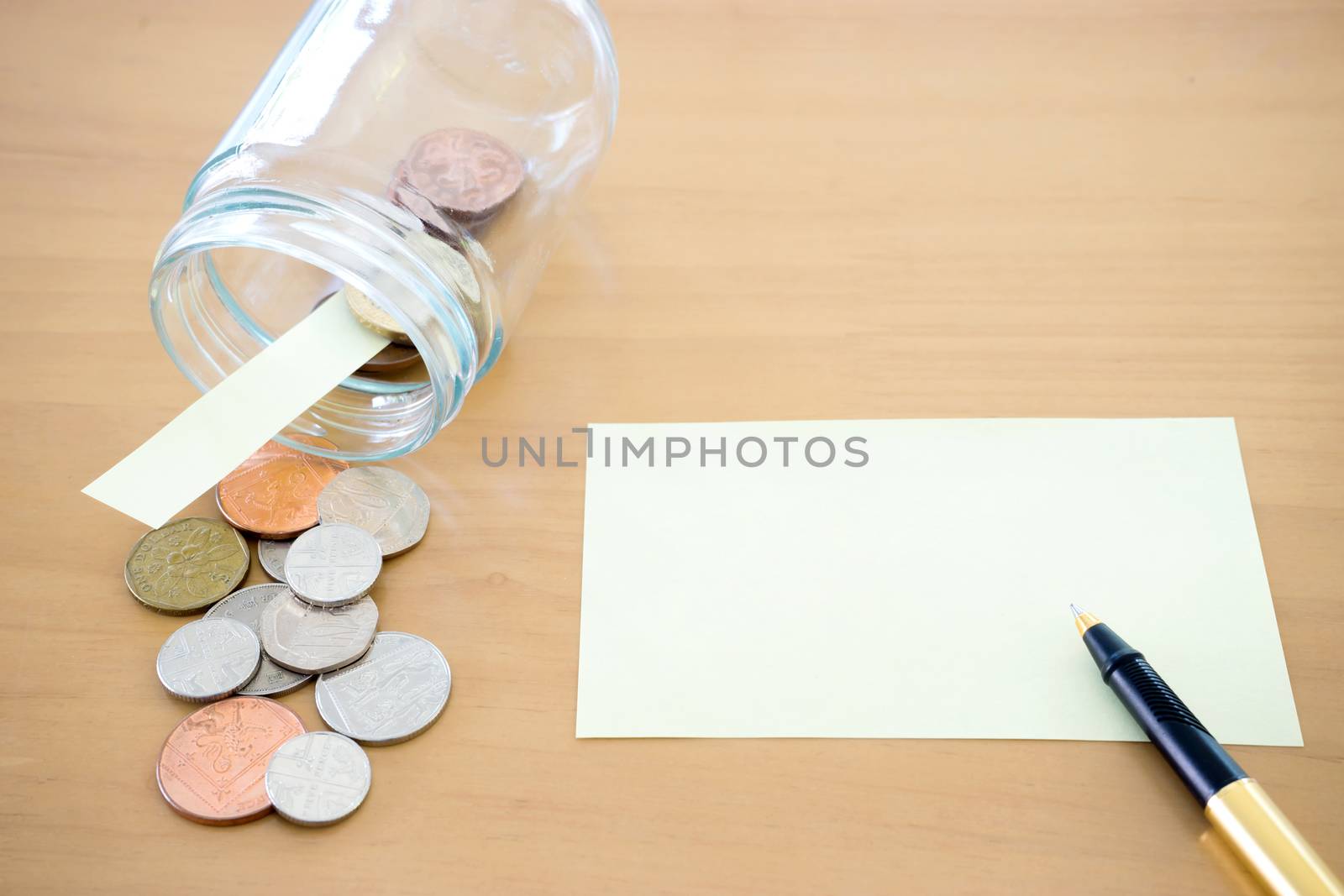 Money jar with U.S. currency represents savings, donations concepts.