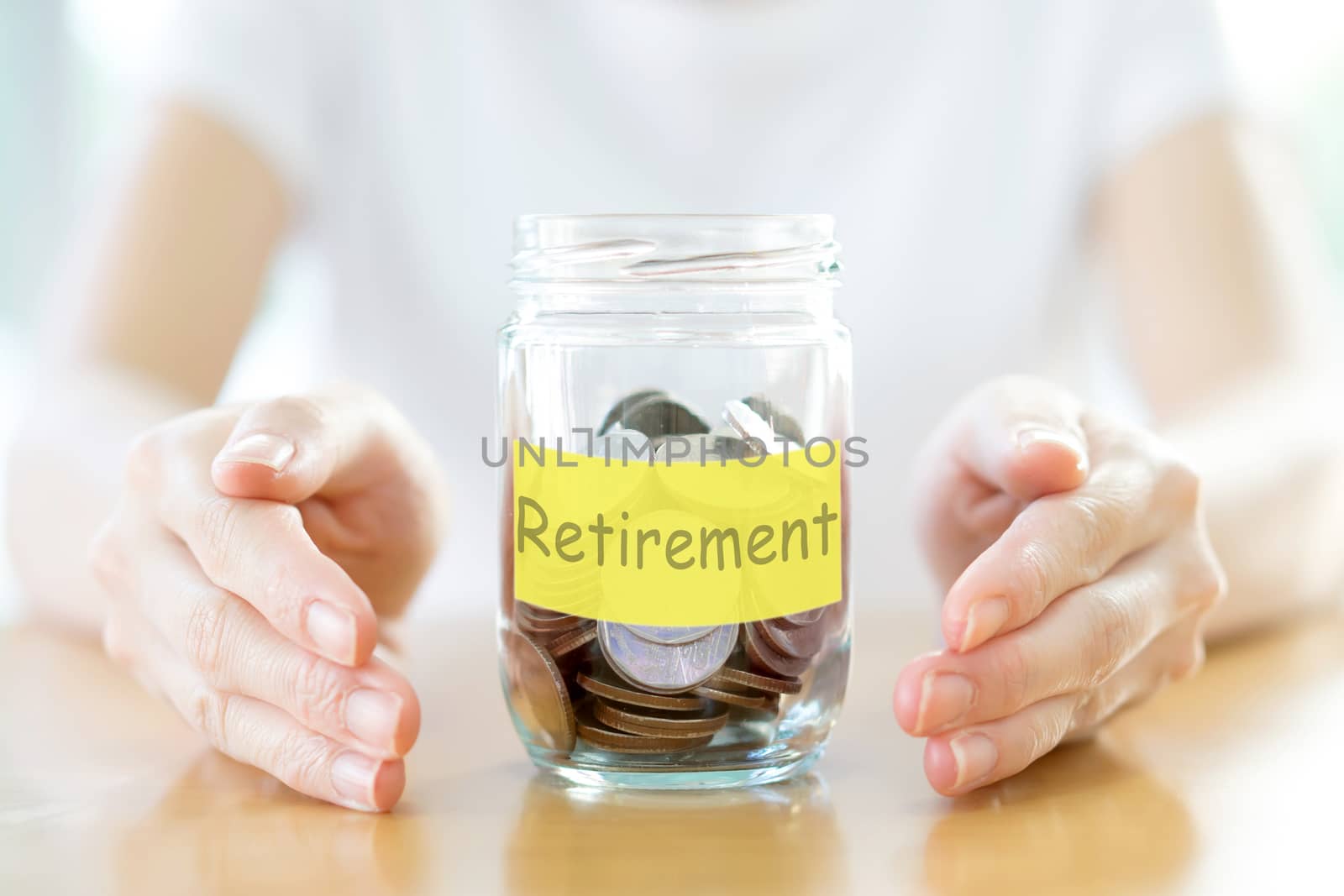 Woman holding money jar with coins close up