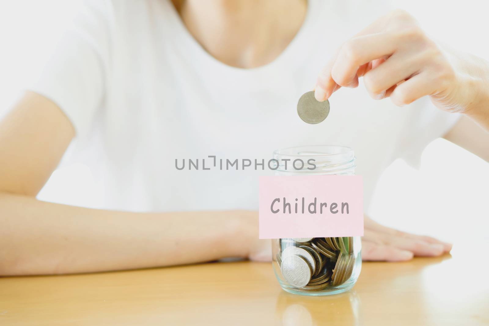 Woman hands with coins in glass jar, close up by ekachailo